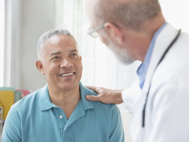 Blue Shirt Hispanic Man with Caucasian Doctor