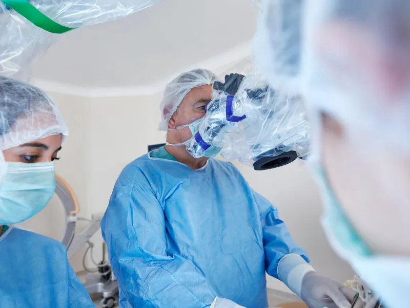 A doctor using a machine to assist in surgery