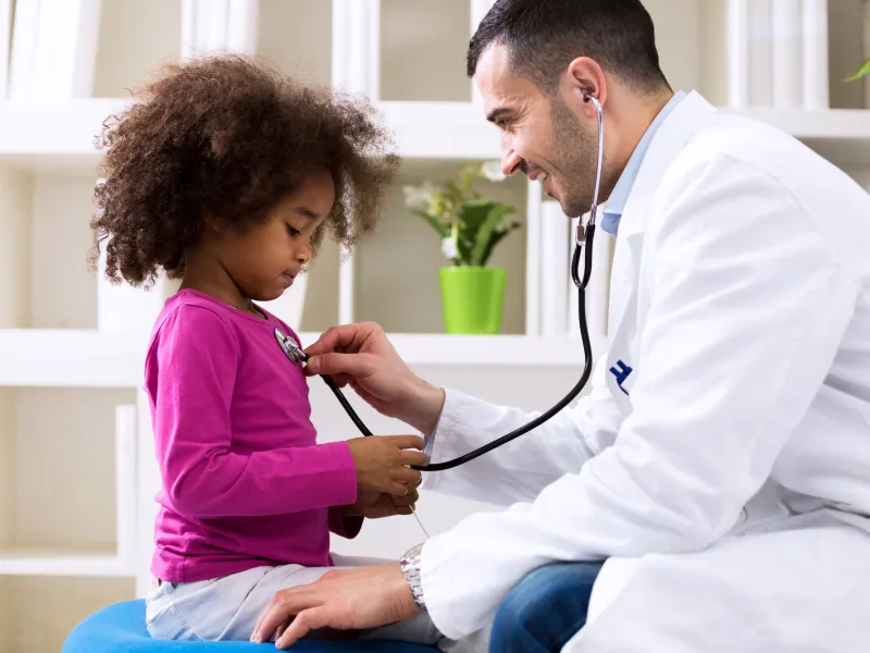 A little girl gets a check up at her doctor's office.