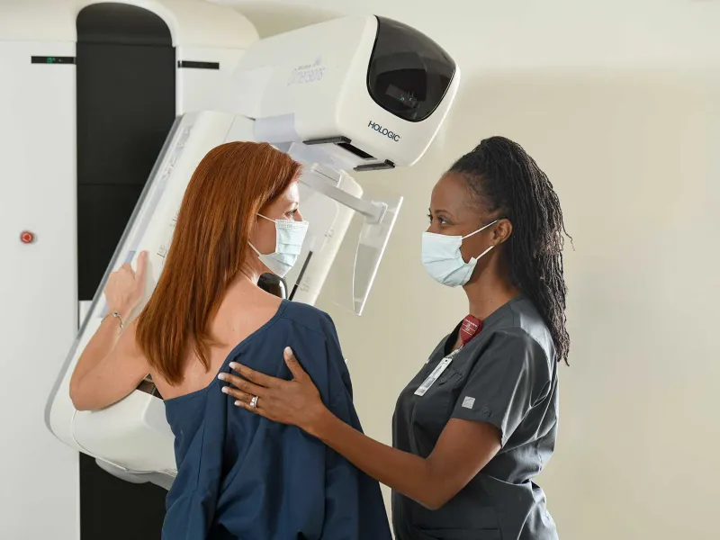 A woman being helped by her nurse for an x-ray