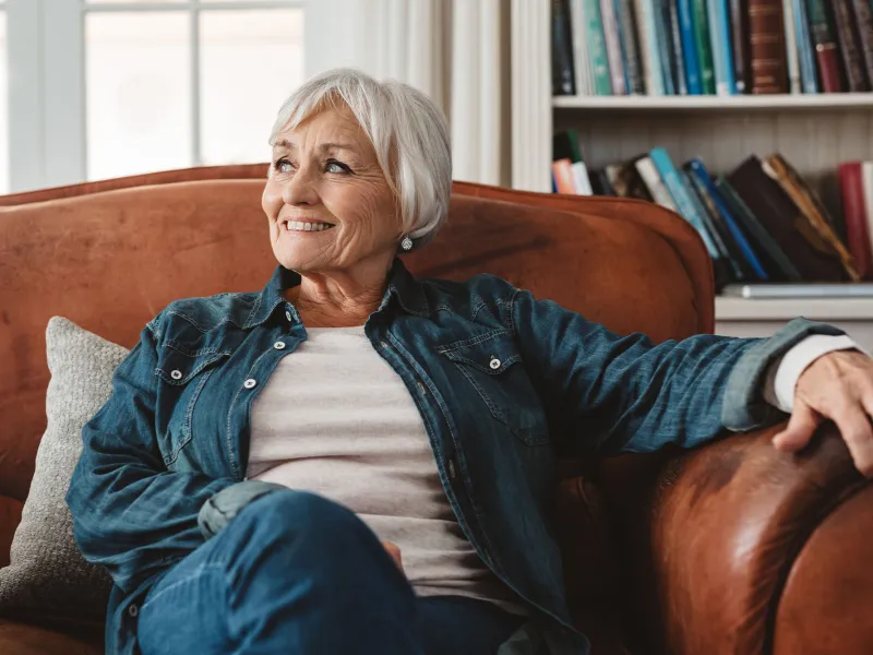 A woman relaxing at home on her couch.