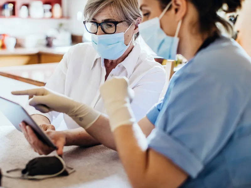A woman reviews her test results with her provider safely. 