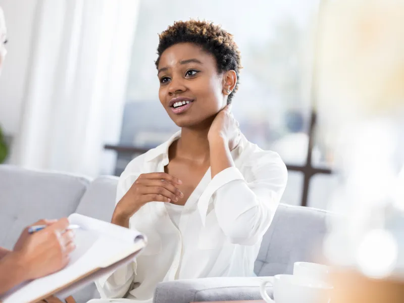 hero-young-woman-touches-throat