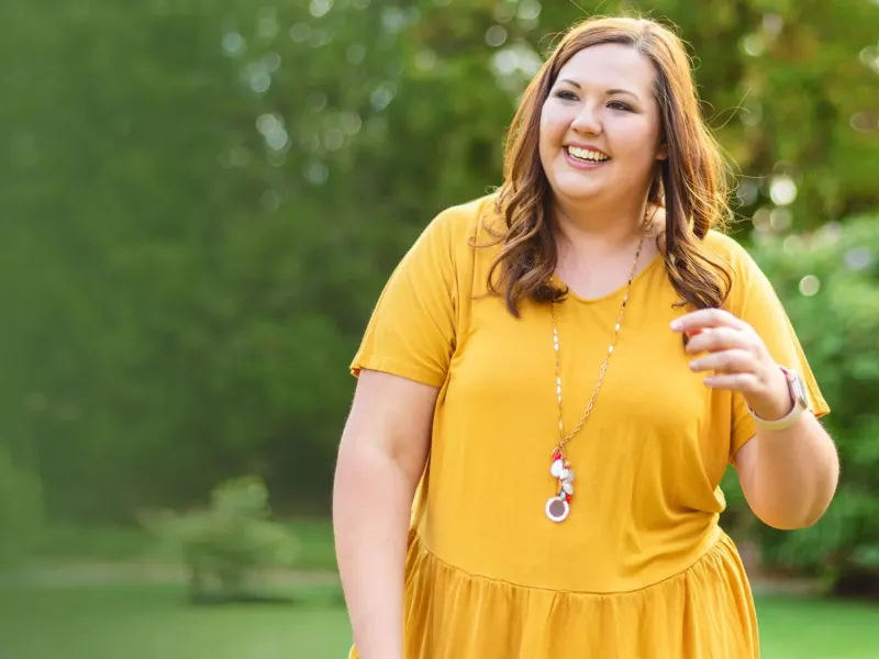 woman outside in yellow dress