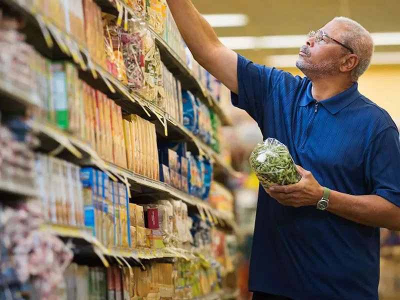 Man at the supermarket shopping for food