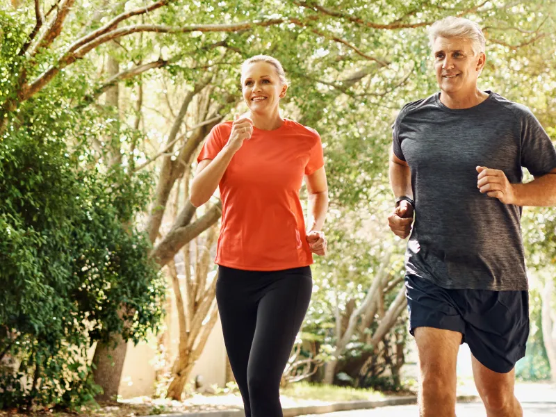 A Couple Jogging Through the Woods