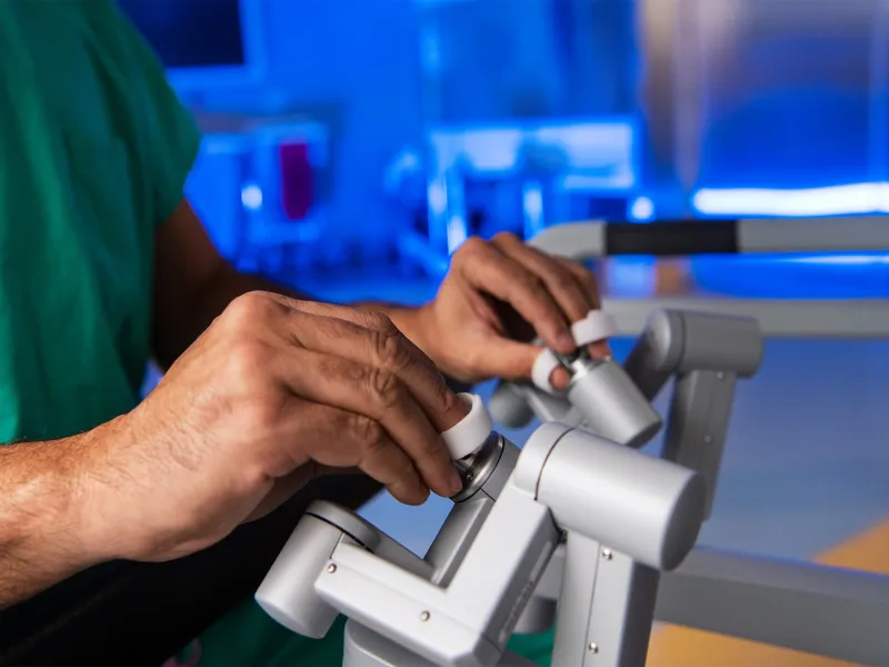 physician using robotic surgery controls