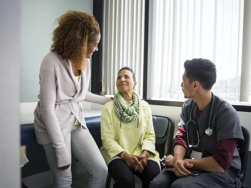 Older woman and her daughter with a nurse