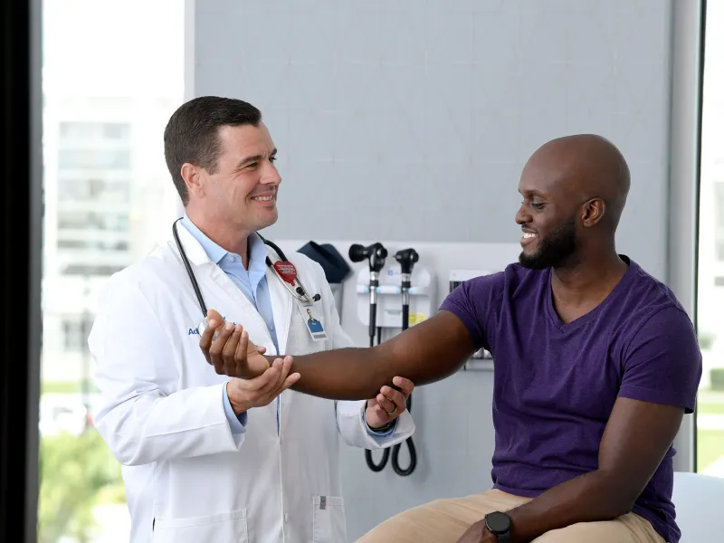Doctor checking patient's arm.