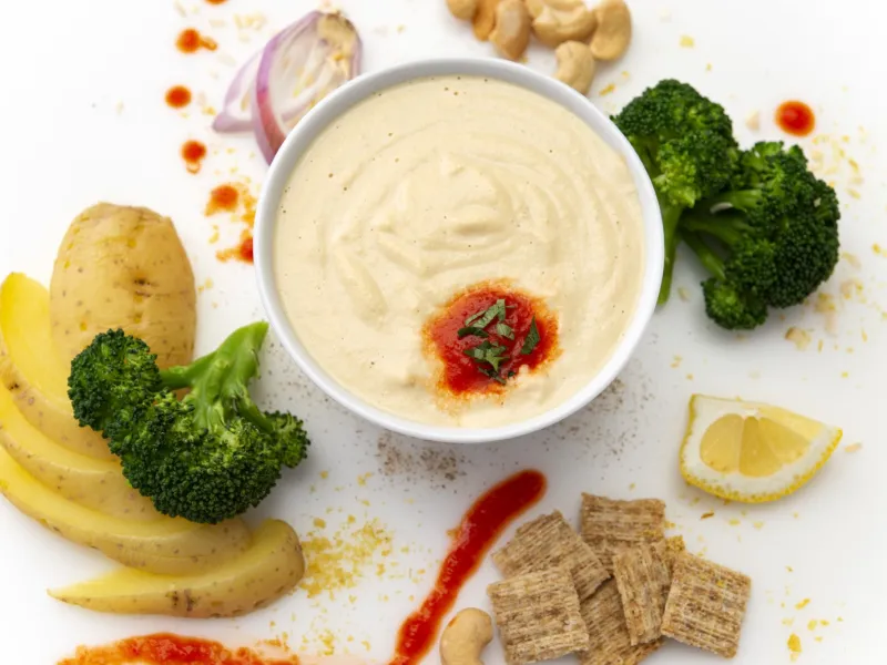 Cashew Jack Drizzle dish surrounded by vegetables