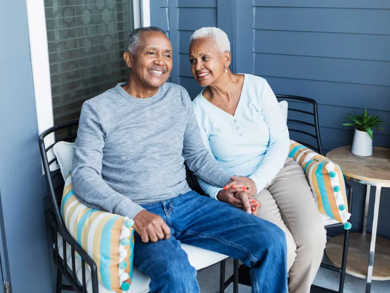 A senior couple out on their porch