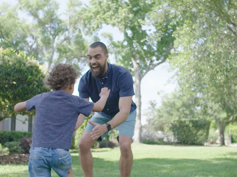 AdventHealth stroke patient, Brandon Watson, about to pick up his son.