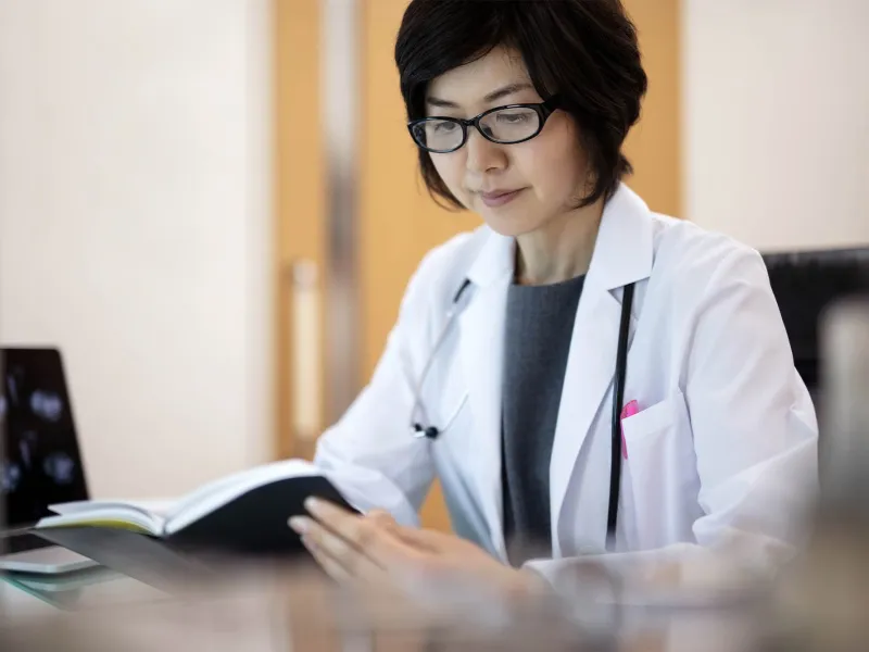 A female doctor reviews materials. 