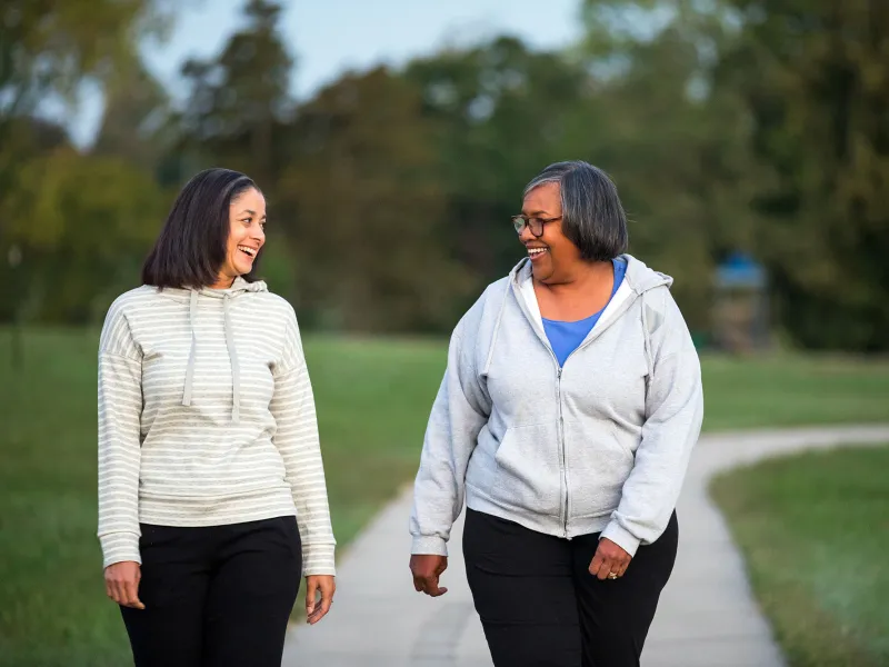 Two women taking a morning walk in the park.
