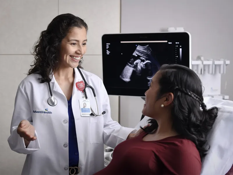A pregnant woman talking to her doctor about imaging results