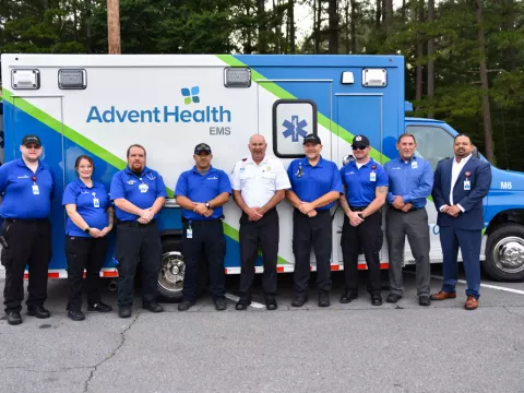EMS Team stands in front of new ambulance