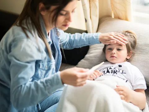 A mother checking her child's fever