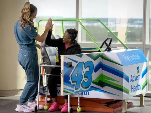 A female patient hi-fiving her healthcare provider