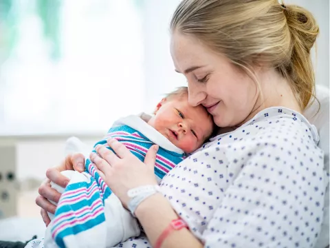 A mom holding her newborn.
