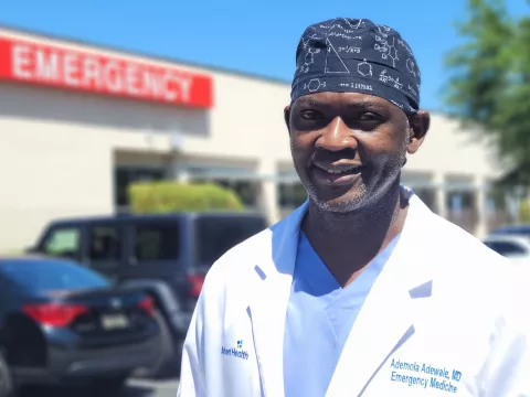 Ademola Adewale, MD in front of Emergency Department at East Orlando