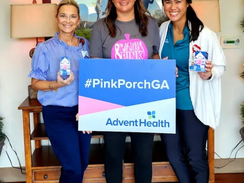 Lacee Landru (middle) holds up the PinkPorchGA sign with Cedartown clinic practice manager Tammy Jarrell and her oncology occupational therapist, Carolyn Perry.