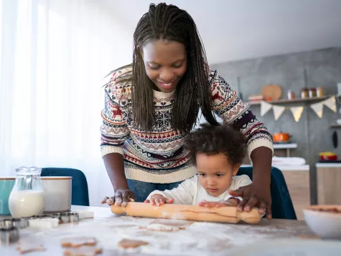A mother and her daughter cooking holiday dinner together