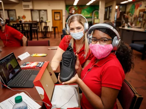 Student smiles after receiving new shoes from AdventHealth