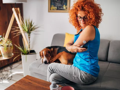 A Female Diabetic Scans Her Freestyle Libre to Check Her Glucose Levels.