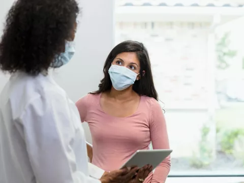 A patient listening to her provider with attention