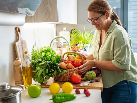 A Woman Prepares Vegetables in the Kitchen of Her Home