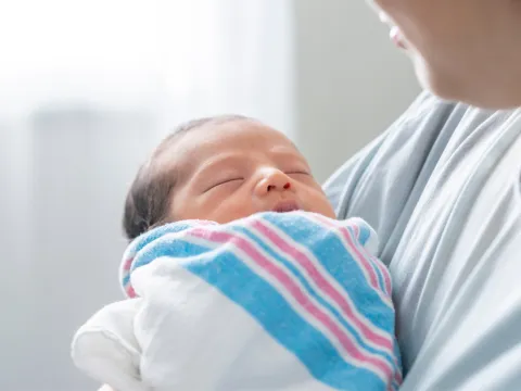 A Close Up of a New Born Baby Being Held