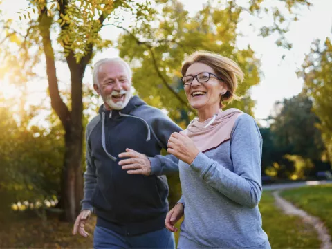 A Senior Couple Goes for a Run in a Park
