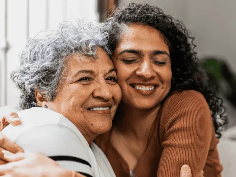 A Daughter Hugs Her Senior Mom at Home