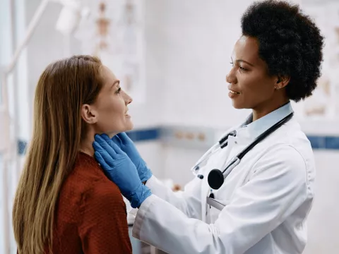 A Physician Checks Her Patient's Throat in a Practice Office.