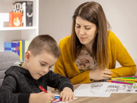 A Mother Helps Her Child with His Homework