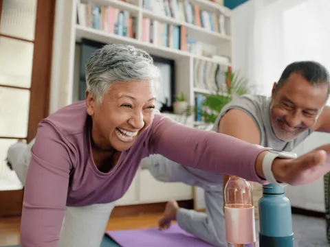 Senior Woman and Man doing pilates together at home.