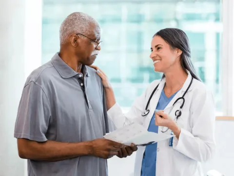 Man with doctor reviewing pamphlet
