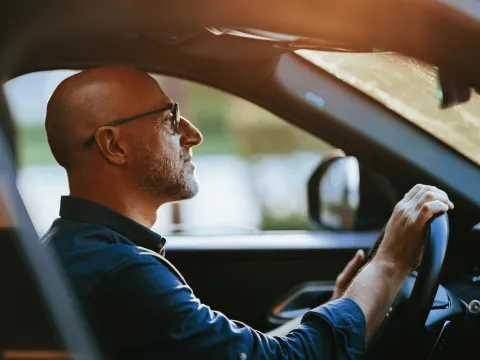 Bald Man Driving Car