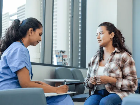 A Woman Speaks to a Provider as the Physician Takes Notes