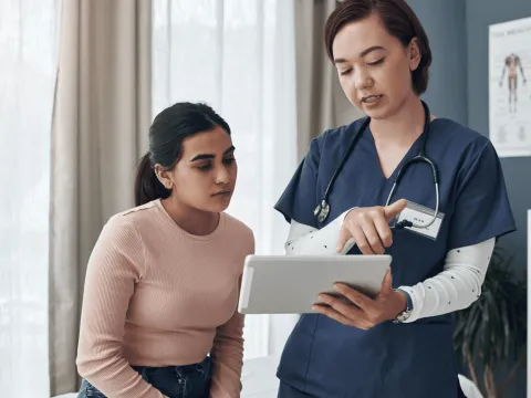 A Doctor Goes Over a Chart with her Patient