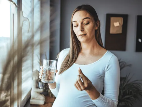 Woman taking pregnancy pill