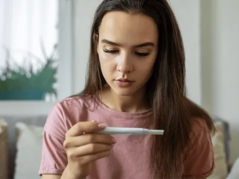 Woman looking at pregnancy test