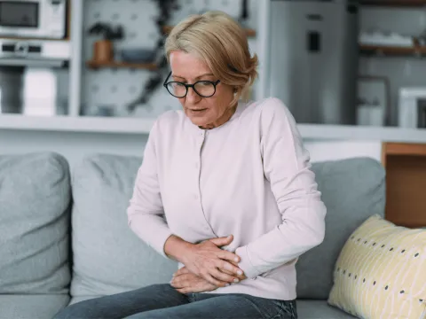 Woman grabbing her stomach 