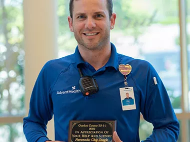 Chip Seagle holds his 911 Telecommunications award.