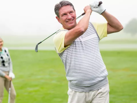 A couple enjoys a game of golf.