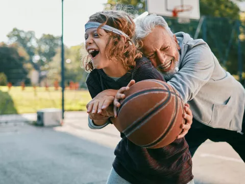 A boy and his grandpa shoot around