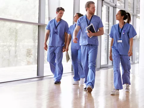Group of nurses walking in the hall.