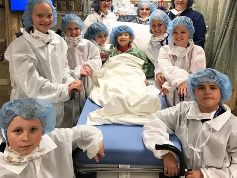 nurses gathered around a patient