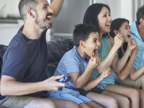 A family cheers for their favorite sports team.