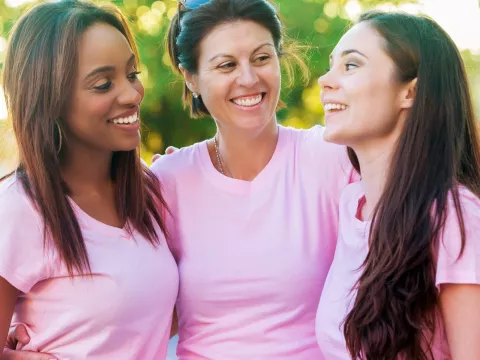 Three women in pink shirts